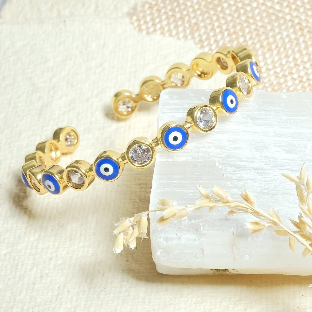 Stylish evil eye cuff bangles crafted in stainless steel with an adjustable design, available in black, blue, red, white, green, and rainbow shades, perfect for everyday wear and trendy protective styling.