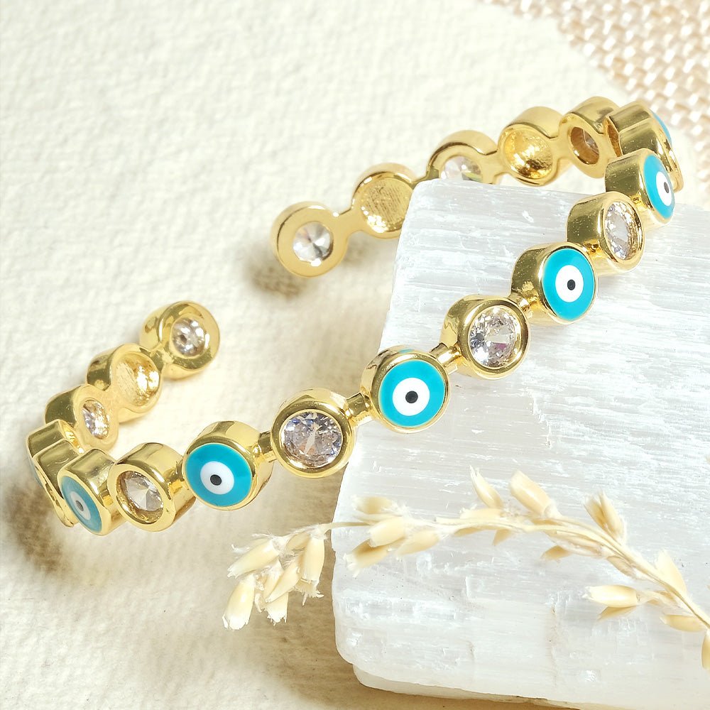 Stylish evil eye cuff bangles crafted in stainless steel with an adjustable design, available in black, blue, red, white, green, and rainbow shades, perfect for everyday wear and trendy protective styling.

