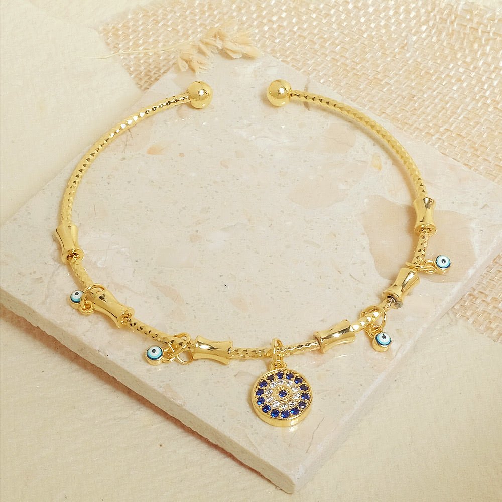 Minimal golden charm bangle with a sleek adjustable design and anti-tarnish finish, perfect for everyday wear, dainty styling, and effortless chic looks.