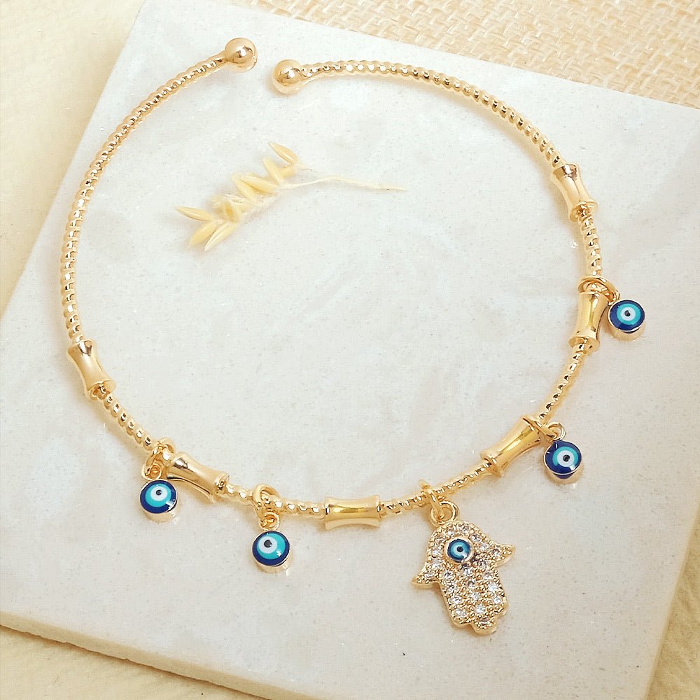 Minimal golden charm bangle with a sleek adjustable design and anti-tarnish finish, perfect for everyday wear, dainty styling, and effortless chic looks.