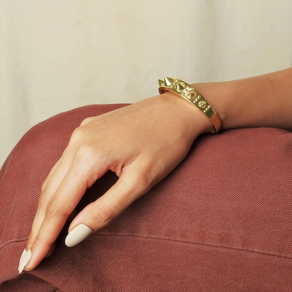 Bold golden spike cuff bangle with an edgy adjustable design and anti-tarnish finish, perfect for statement styling, parties, and modern glam looks.
