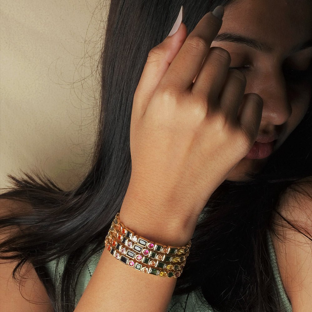 Stylish multi-colored cuff bangle with heart, pearl, and geometric charm detailing and an adjustable anti-tarnish finish, perfect for playful stacking, everyday glam, and trendy statement styling.