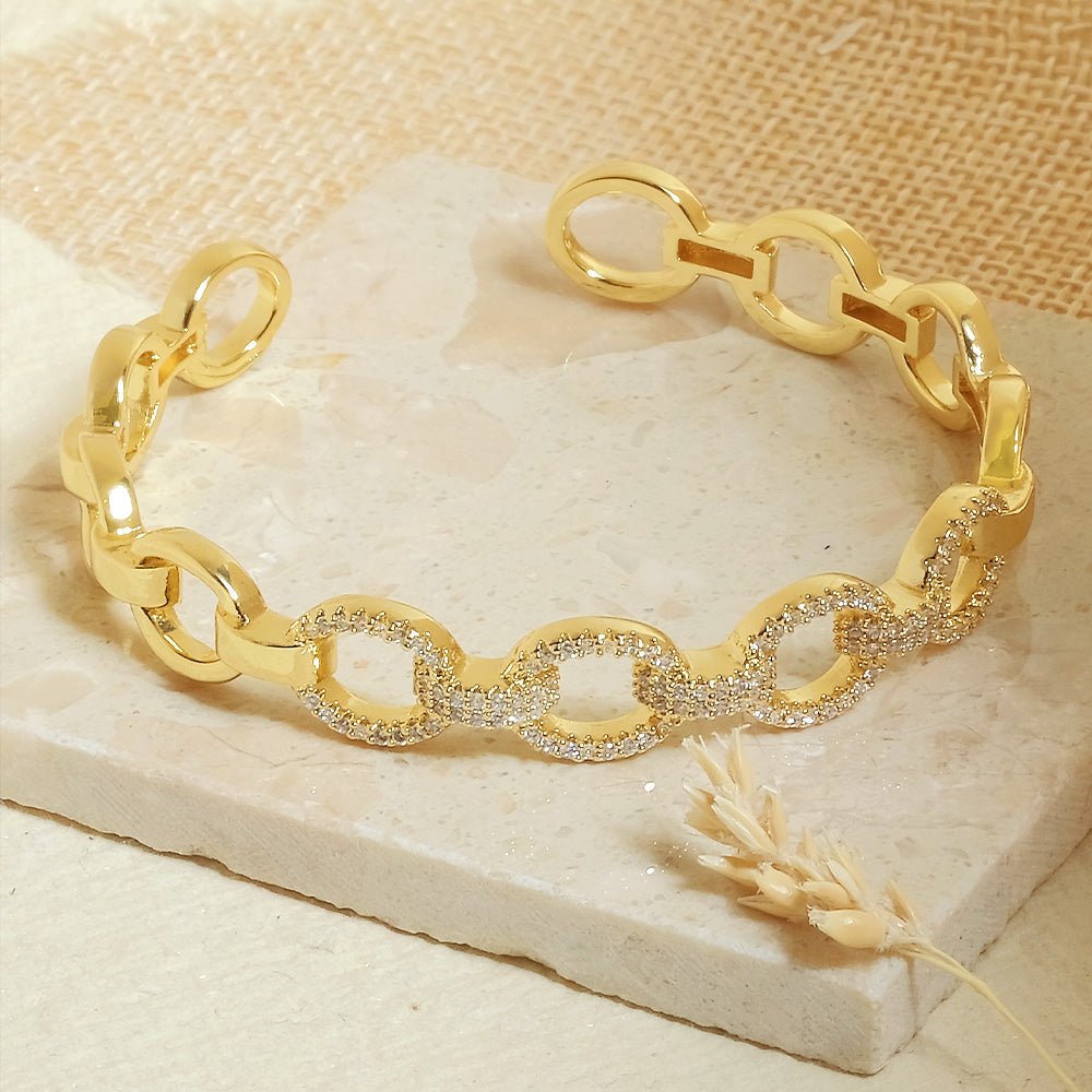 Elegant golden oval link cuff bangle with sparkling stone detailing and an adjustable anti-tarnish finish, perfect for everyday elegance, parties, and chic stacked styling.
